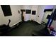 Home gym featuring rower, weights, mirrors, and padded flooring at 3097 Trinity Grove Dr, Dacula, GA 30019