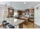 Bright kitchen boasts granite countertops, a kitchen island and modern lighting fixtures at 3097 Trinity Grove Dr, Dacula, GA 30019