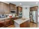 Well-equipped kitchen featuring stainless steel appliances, granite counters, and convenient island at 3097 Trinity Grove Dr, Dacula, GA 30019