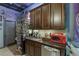 Unique kitchenette area with dark wood cabinets, sleek appliances, and decorative accents at 3097 Trinity Grove Dr, Dacula, GA 30019