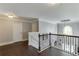 Upstairs landing with hardwood floors, decorative railing, and an arched window at 3097 Trinity Grove Dr, Dacula, GA 30019