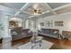 Open-concept living room with hardwood floors, coffered ceiling, and archways to other rooms at 3097 Trinity Grove Dr, Dacula, GA 30019