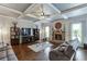 Living room with hardwood floors, a fireplace, built-in shelves, and coffered ceilings at 3097 Trinity Grove Dr, Dacula, GA 30019