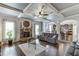 Bright living room features hardwood floors, a stone fireplace, and coffered ceilings at 3097 Trinity Grove Dr, Dacula, GA 30019