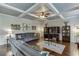 Living room boasts hardwood floors, coffered ceiling, with built-in shelves and media console at 3097 Trinity Grove Dr, Dacula, GA 30019