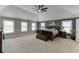 Spacious main bedroom with a ceiling fan, neutral carpet, and plenty of natural light at 3097 Trinity Grove Dr, Dacula, GA 30019