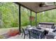 Back porch view showing patio furniture, string lights, and a private backyard at 3097 Trinity Grove Dr, Dacula, GA 30019