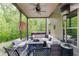 Covered patio with seating, fire pit, hot tub and backyard views at 3097 Trinity Grove Dr, Dacula, GA 30019