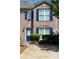 Charming brick townhome featuring blue shutters, a well-maintained lawn and inviting curb appeal at 212 Meadowlark Place, Austell, GA 30168