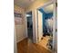 A hallway with a view of a bathroom featuring bold blue walls and a shower curtain at 212 Meadowlark Place, Austell, GA 30168