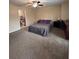 Spacious bedroom with neutral walls, carpet, a ceiling fan, and glimpses of an ensuite bathroom at 212 Meadowlark Place, Austell, GA 30168
