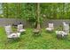 Inviting backyard with comfortable seating around a fire pit and a grill for outdoor entertaining at 10044 Point View Dr, Jonesboro, GA 30238