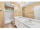 Well-lit bathroom features a double sink vanity and shower/tub combo with tile surround at 10044 Point View Dr, Jonesboro, GA 30238