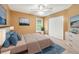 Stylish bedroom features a king bed, white closet doors, blue area rug and neutral walls at 10044 Point View Dr, Jonesboro, GA 30238