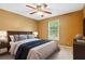 Comfortable bedroom featuring neutral walls, soft carpet, ceiling fan, and plenty of natural light at 10044 Point View Dr, Jonesboro, GA 30238
