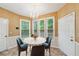 Charming breakfast nook with natural light and chandelier with seating for four at 10044 Point View Dr, Jonesboro, GA 30238