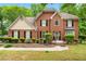 Traditional brick home with manicured landscaping and a welcoming front entrance at 10044 Point View Dr, Jonesboro, GA 30238