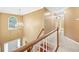 Grand foyer with staircase featuring wood railing, natural light from arched window, and decorative chandelier at 10044 Point View Dr, Jonesboro, GA 30238