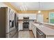Well-lit kitchen featuring stainless steel appliances, white cabinets, and modern fixtures at 10044 Point View Dr, Jonesboro, GA 30238