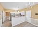 Bright kitchen with stainless steel appliances and white cabinetry featuring modern chandelier lighting at 10044 Point View Dr, Jonesboro, GA 30238