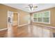 Spacious living room showcasing hardwood floors, a ceiling fan, and lots of natural light through large windows at 10044 Point View Dr, Jonesboro, GA 30238