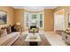 Inviting living room with a bay window, comfortable seating, and stylish decor elements at 10044 Point View Dr, Jonesboro, GA 30238