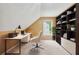 Bright office space with modern desk, chair, and a built in bookcase for organized storage at 10044 Point View Dr, Jonesboro, GA 30238