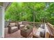 Outdoor patio area with wicker furniture, sofa, and a glass coffee table at 10044 Point View Dr, Jonesboro, GA 30238