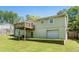 View of the back of the home featuring a deck, walk out basement and a large yard at 1085 Azalea Ne Cir, Marietta, GA 30062