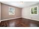 Cozy bedroom with wood floors, two windows providing natural light, and neutral paint at 1085 Azalea Ne Cir, Marietta, GA 30062