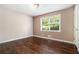 Inviting bedroom with wood floors, a window for natural light, and fresh neutral paint at 1085 Azalea Ne Cir, Marietta, GA 30062