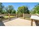 Wide angle view of a wooden deck with bench overlooking grass and treeline at 1085 Azalea Ne Cir, Marietta, GA 30062
