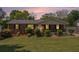 Charming brick home with a well-maintained lawn and inviting curb appeal, black shutters, and a cozy front porch at 1085 Azalea Ne Cir, Marietta, GA 30062