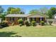 Charming brick home with a well-maintained lawn and inviting curb appeal, black shutters, and a cozy front porch at 1085 Azalea Ne Cir, Marietta, GA 30062