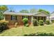 Inviting brick home with lush lawn, manicured bushes, and a classic design at 1085 Azalea Ne Cir, Marietta, GA 30062