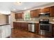 Bright kitchen featuring stainless appliances, wood cabinets, light counters, and wood-look flooring at 1085 Azalea Ne Cir, Marietta, GA 30062