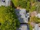Aerial view of home with mature trees showcasing the roof and surrounding property at 1144 Bellewood Sq, Dunwoody, GA 30338