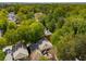 Lush green trees surround homes, offering a secluded, peaceful residential setting with city views in the distance at 1144 Bellewood Sq, Dunwoody, GA 30338