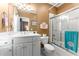 Well-lit bathroom featuring a vanity with a sink, toilet, and glass-enclosed shower at 1144 Bellewood Sq, Dunwoody, GA 30338