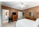 Warm bedroom with a ceiling fan, double doors to the bathroom, and neutral decor at 1144 Bellewood Sq, Dunwoody, GA 30338