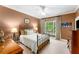 Inviting bedroom with iron bed frame, a ceiling fan, and a window at 1144 Bellewood Sq, Dunwoody, GA 30338