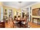 Charming dining room featuring hardwood floors, a chandelier, and an open floor plan at 1144 Bellewood Sq, Dunwoody, GA 30338