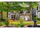Elegant brick home featuring a well-manicured lawn with bench and beautiful water fountain at 1144 Bellewood Sq, Dunwoody, GA 30338