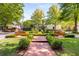 Scenic view of landscaped common area with benches and manicured hedges at 1144 Bellewood Sq, Dunwoody, GA 30338