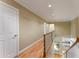 Bright hallway with hardwood floors, white trim, and staircase with wood railing at 1144 Bellewood Sq, Dunwoody, GA 30338