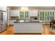 Open-concept kitchen with island cooktop, granite counters, stainless appliances, and white cabinetry at 1144 Bellewood Sq, Dunwoody, GA 30338
