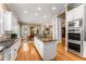 Spacious kitchen with granite counters, hardwood floors, and stainless steel appliances at 1144 Bellewood Sq, Dunwoody, GA 30338