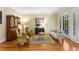 Bright and airy living room featuring hardwood floors and French doors to the exterior at 1144 Bellewood Sq, Dunwoody, GA 30338