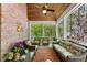 Relaxing screened porch with ceiling fan, brick accents, and outdoor furniture at 1144 Bellewood Sq, Dunwoody, GA 30338