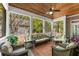 Comfortable screened porch with wood ceiling, ceiling fan, and wicker furniture at 1144 Bellewood Sq, Dunwoody, GA 30338